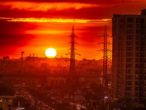 Preview wallpaper city, buildings, road, sun, sunset, dark