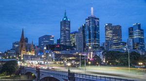 Preview wallpaper city, buildings, road, bridge, lights, twilight