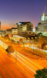 Preview wallpaper city, buildings, road, twilight, lights, aerial view