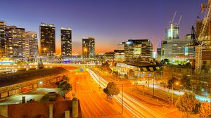 Preview wallpaper city, buildings, road, twilight, lights, aerial view