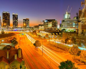 Preview wallpaper city, buildings, road, twilight, lights, aerial view