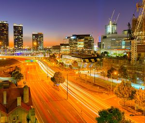 Preview wallpaper city, buildings, road, twilight, lights, aerial view