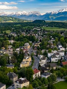Preview wallpaper city, buildings, road, mountains, aerial view