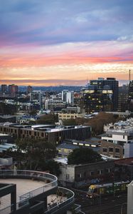 Preview wallpaper city, buildings, roofs, sunset