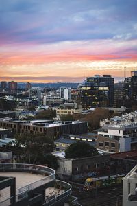 Preview wallpaper city, buildings, roofs, sunset