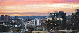 Preview wallpaper city, buildings, roofs, sunset