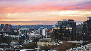 Preview wallpaper city, buildings, roofs, sunset