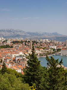 Preview wallpaper city, buildings, roofs, aerial view, architecture, trees