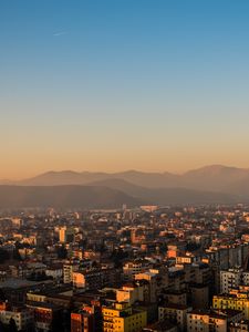 Preview wallpaper city, buildings, roofs, mountains, aerial view