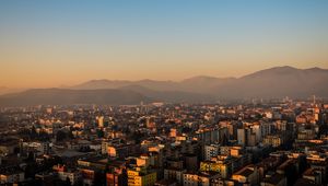 Preview wallpaper city, buildings, roofs, mountains, aerial view