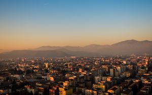 Preview wallpaper city, buildings, roofs, mountains, aerial view