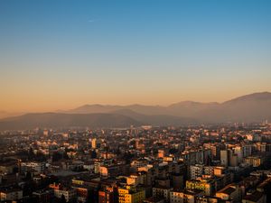 Preview wallpaper city, buildings, roofs, mountains, aerial view