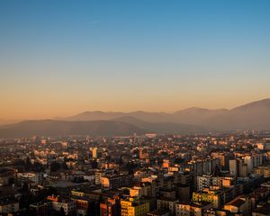 Preview wallpaper city, buildings, roofs, mountains, aerial view