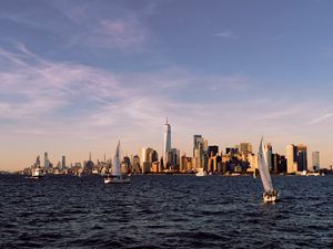 Preview wallpaper city, buildings, sailboat, water