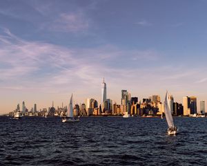 Preview wallpaper city, buildings, sailboat, water