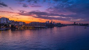 Preview wallpaper city, buildings, sea, dusk