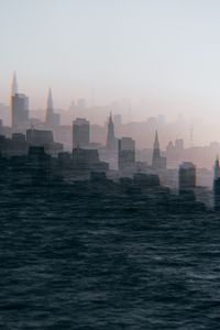 Preview wallpaper city, buildings, silhouettes, illusion, water, waves