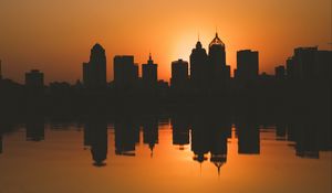 Preview wallpaper city, buildings, silhouettes, sunset, water, reflection, dark