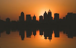 Preview wallpaper city, buildings, silhouettes, sunset, water, reflection, dark
