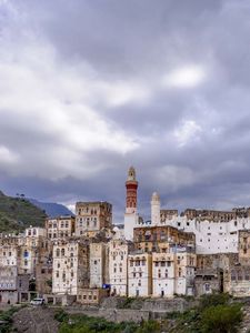 Preview wallpaper city, buildings, sky, hills, clouds