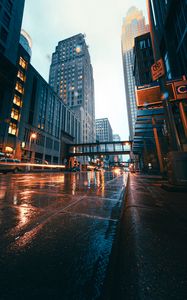 Preview wallpaper city, buildings, skyscrapers, road, rain