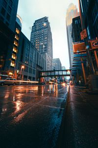 Preview wallpaper city, buildings, skyscrapers, road, rain
