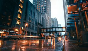 Preview wallpaper city, buildings, skyscrapers, road, rain