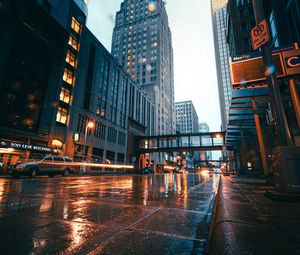 Preview wallpaper city, buildings, skyscrapers, road, rain