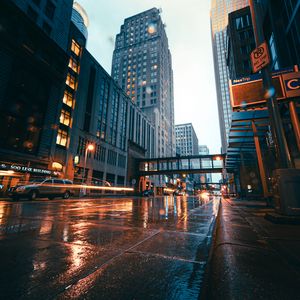 Preview wallpaper city, buildings, skyscrapers, road, rain