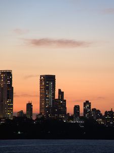 Preview wallpaper city, buildings, skyscrapers, water, evening