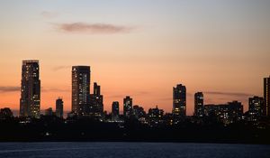 Preview wallpaper city, buildings, skyscrapers, water, evening