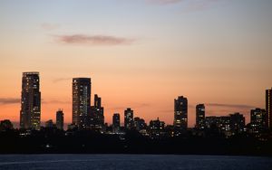 Preview wallpaper city, buildings, skyscrapers, water, evening