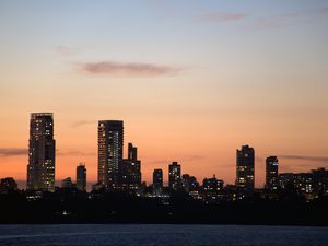 Preview wallpaper city, buildings, skyscrapers, water, evening