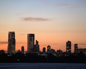 Preview wallpaper city, buildings, skyscrapers, water, evening