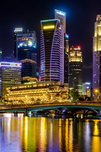 Preview wallpaper city, buildings, skyscrapers, backlight, water, night