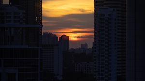 Preview wallpaper city, buildings, sun, sunset