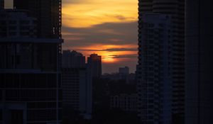 Preview wallpaper city, buildings, sun, sunset