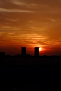 Preview wallpaper city, buildings, sun, sunset, dark