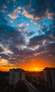 Preview wallpaper city, buildings, sunset, clouds, parking