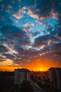 Preview wallpaper city, buildings, sunset, clouds, parking