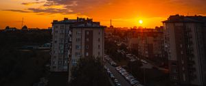 Preview wallpaper city, buildings, sunset, clouds, parking