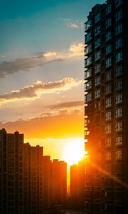 Preview wallpaper city, buildings, sunset, rays