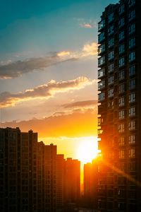 Preview wallpaper city, buildings, sunset, rays