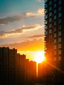 Preview wallpaper city, buildings, sunset, rays