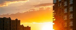 Preview wallpaper city, buildings, sunset, rays