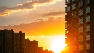 Preview wallpaper city, buildings, sunset, rays