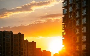 Preview wallpaper city, buildings, sunset, rays