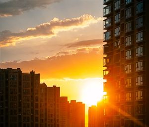 Preview wallpaper city, buildings, sunset, rays