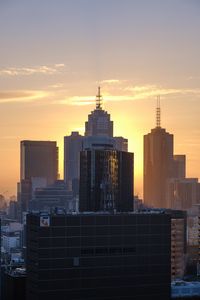 Preview wallpaper city, buildings, sunset, glow