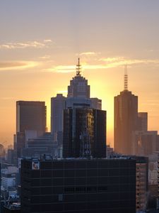 Preview wallpaper city, buildings, sunset, glow